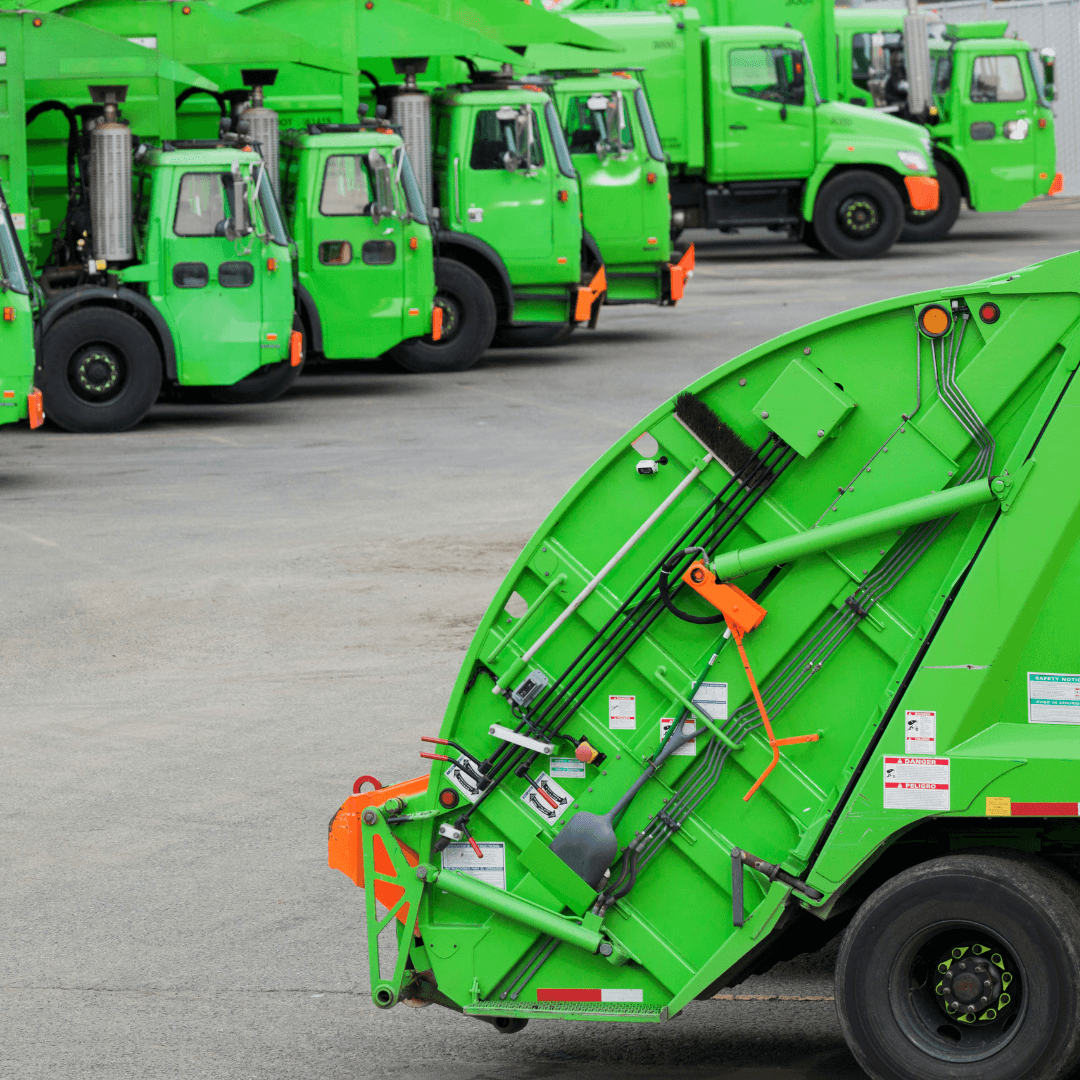 An image of a road paving crew in bright vests running a weiler remixing transfer vehicle and laying new asphalt for a road