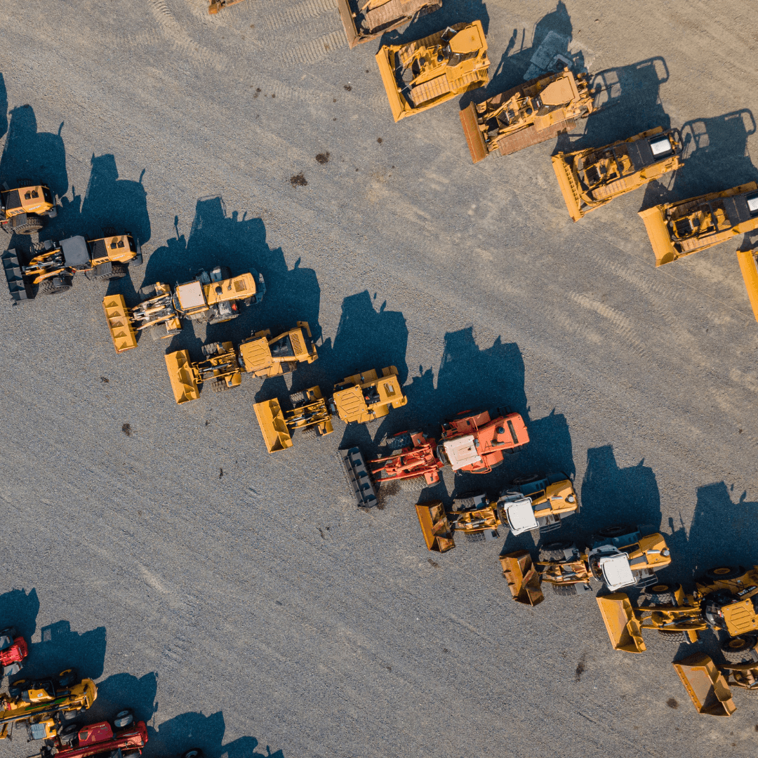 An image of a green John deere tractor in a field pulling a plow with the sunset in the background