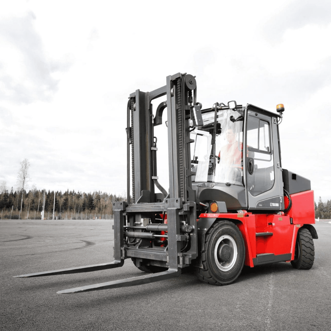 An image of a forklift with a driver in the cab in a parkling lot under a cloudy sky