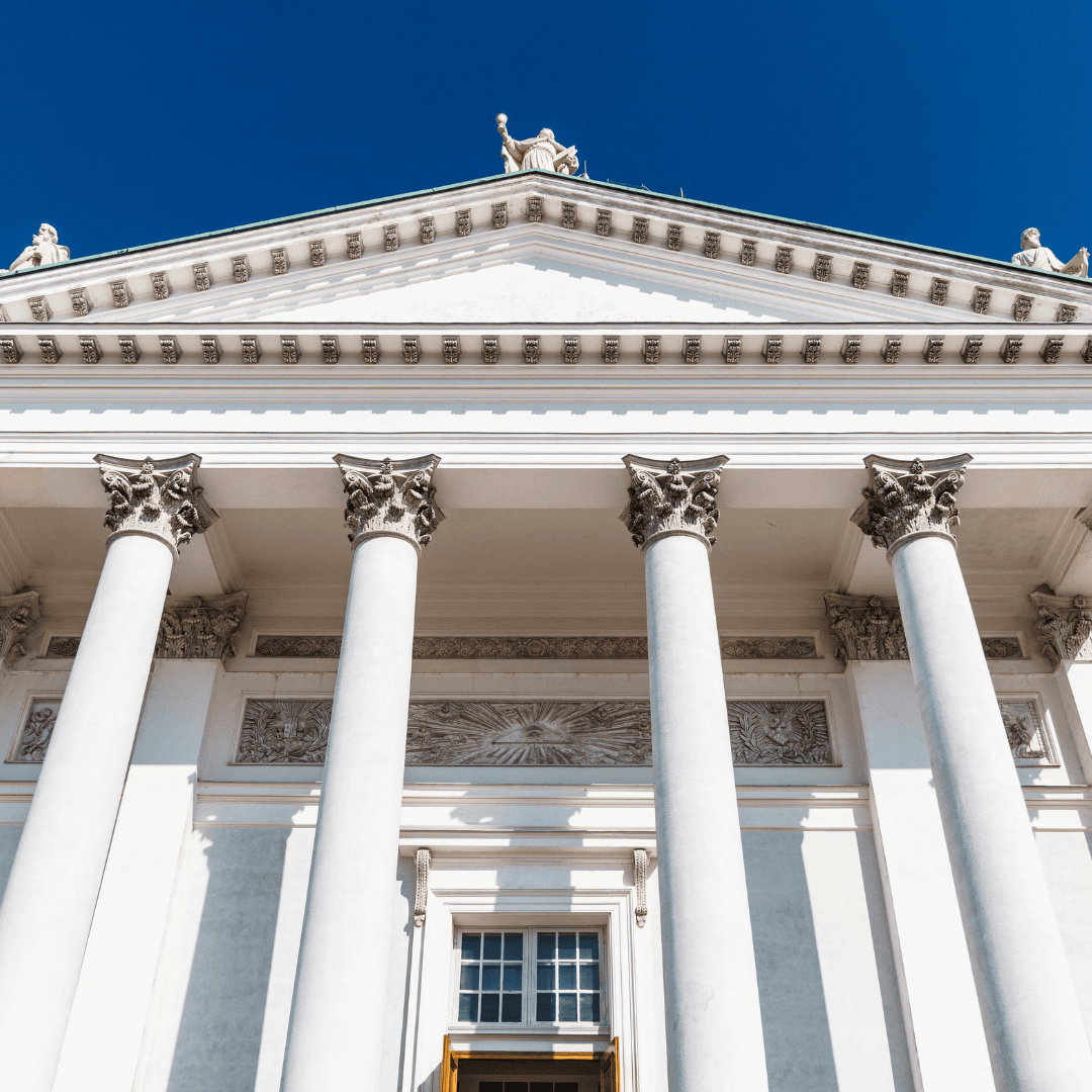 An image of a road paving crew in bright vests running a weiler remixing transfer vehicle and laying new asphalt for a road