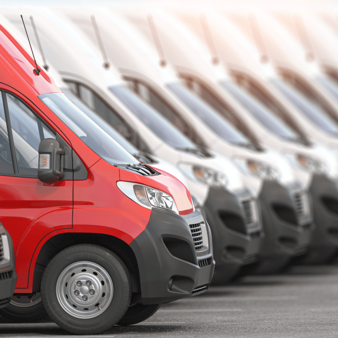 An image of a road paving crew in bright vests running a weiler remixing transfer vehicle and laying new asphalt for a road